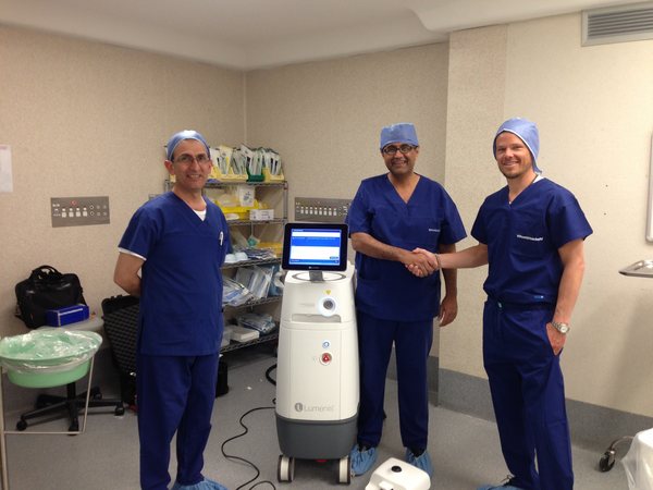 Dr Raji Kooner and colleagues beside a holmium laser platform