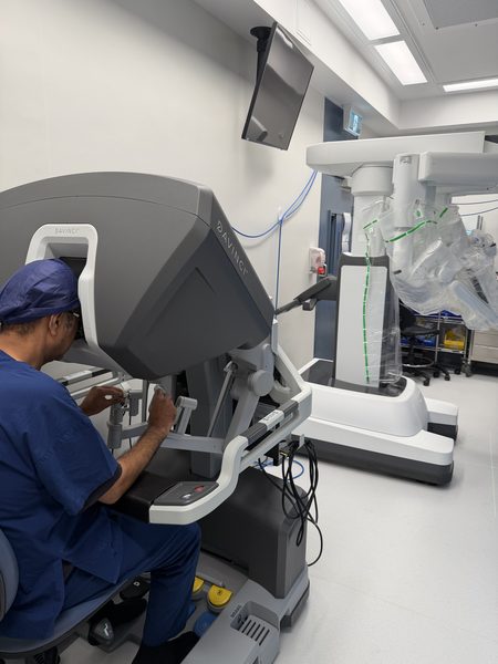 Dr Raji Kooner seated at the da Vinci surgeon console