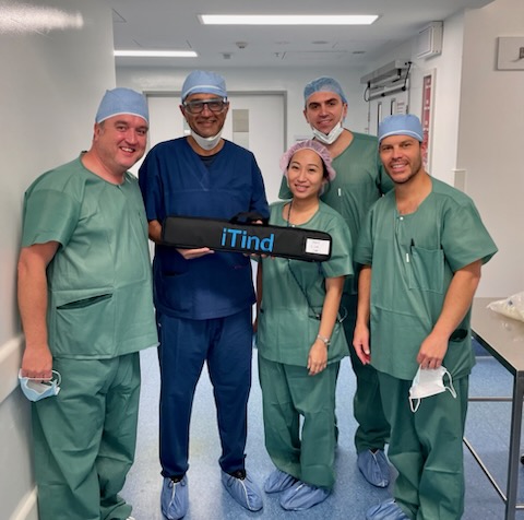 Dr Raji Kooner with the iTind theatre team holding an iTind device